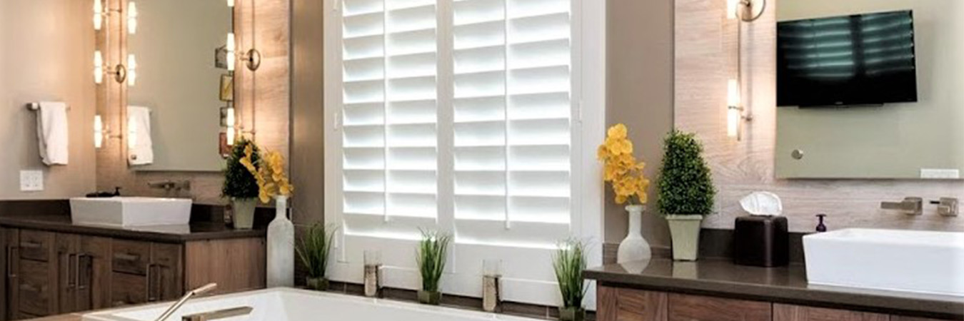 White polywood shutters above a bathtub