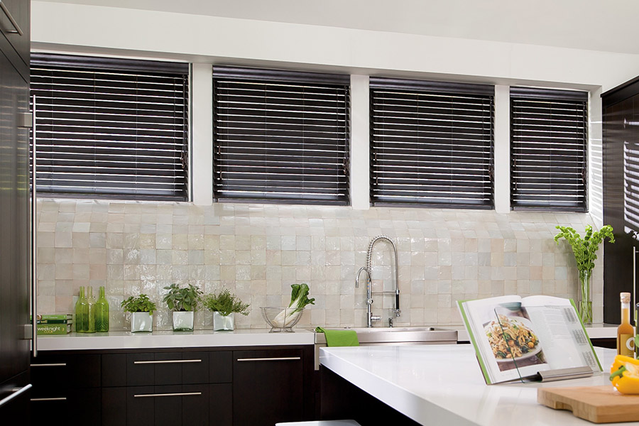 Choose custom Polywood faux wood blinds for your kitchen in New Jersey. Special shaped faux wood blinds in several windows above a sink.