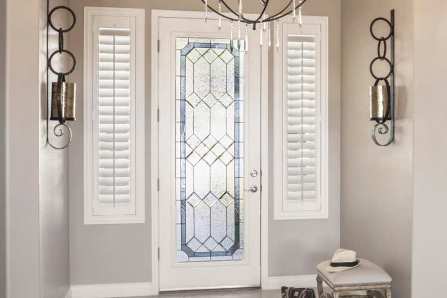 Polywood shutters offer flexibility on the brightness of natural light in New Jersey. Sidelight windows with white polywood shutters in a foyer.